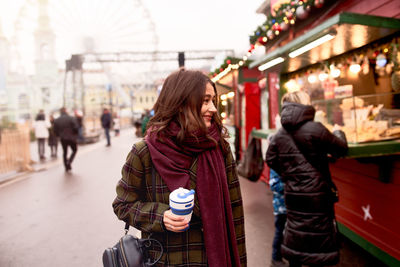 Pretty woman holding reusable coffee cup