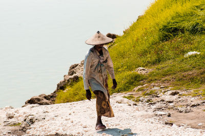 Rear view of people standing on rock