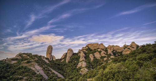 Rock formations on landscape against sky