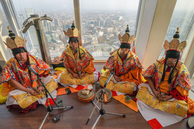 Panoramic view of people sitting in city