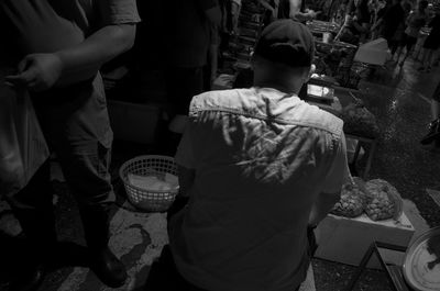 Rear view of people standing at market