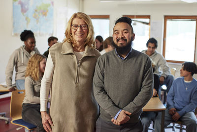 Portrait of teachers with students in background