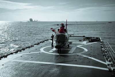 Man on boat in sea against sky