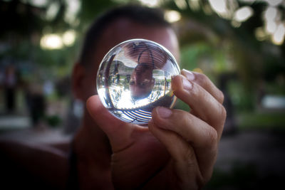 Close-up of hand holding crystal ball