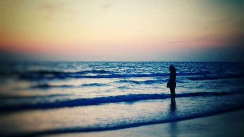 Silhouette of people standing on beach