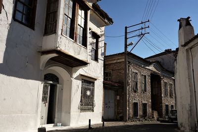 Low angle view of old buildings in town against sky