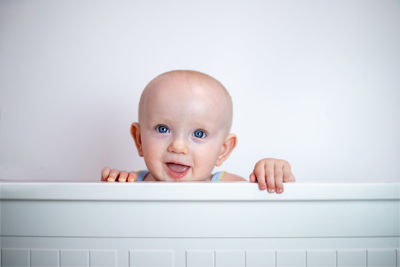 Portrait of cute baby boy in bathtub