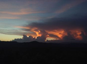 Scenic view of silhouette mountains against sky at sunset