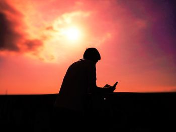 Silhouette of man at sunset