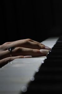 Close-up of hands playing piano