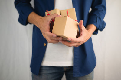 Midsection of man holding camera in box