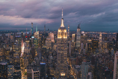 Circa september 2019: breathtaking view of the empire state building at night in manhattan, new york city surrounded by skyscrapers at night