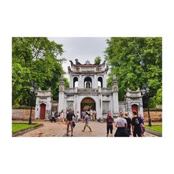 People walking in front of historical building