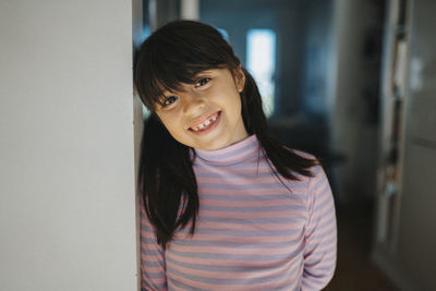 Portrait of happy smiling girl at home