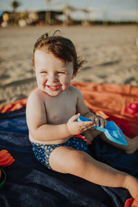 Male toddler enjoying while playing on sunny day at beach
