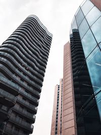 Low angle view of modern buildings against sky in city