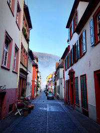 Street amidst buildings against sky