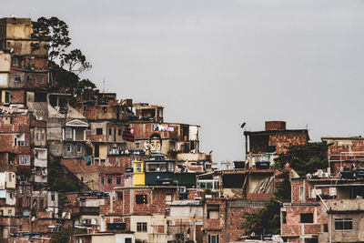 Buildings in city against clear sky