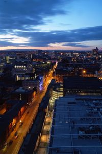 Aerial view of illuminated cityscape against sky at night