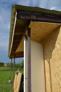 Low angle view of columns on field against sky