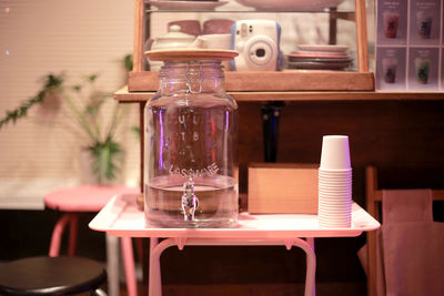 Glass of bottles on table