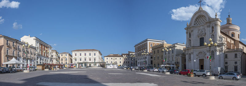 Extra wide angle view of the beautiful piazza duomo in l'aquila with historic buildings and churches