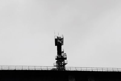 Low angle view of crane against clear sky