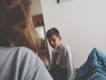 Portrait of boy sitting at home