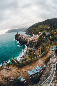 High angle view of townscape by sea against sky