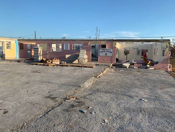 View of abandoned building against blue sky