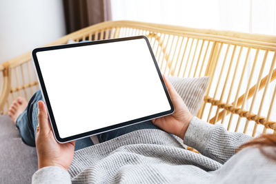 Midsection of woman using digital tablet