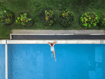 Woman standing by swimming pool