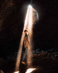 Man with umbrella walking at night