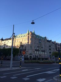 View of buildings against clear blue sky