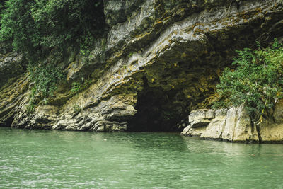 Scenic view of sea against rock formation