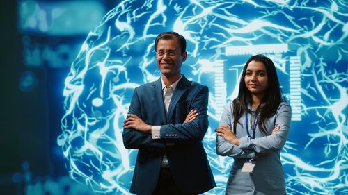 Portrait of business colleagues standing in city at night