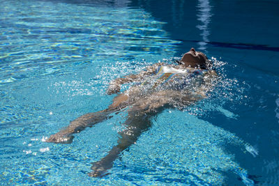 High angle view of woman swimming in pool