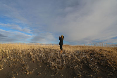 Full length of man standing on field against sky