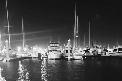 Boats in harbor at night