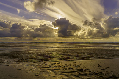 Scenic view of beach against sky during sunset