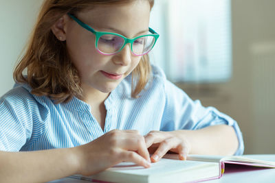 Close-up of girl reading book