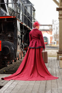 Low section of woman standing in train