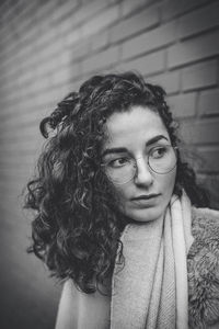 Close-up of young woman wearing eyeglasses while looking away