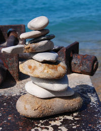 Stack of rusty metal by sea