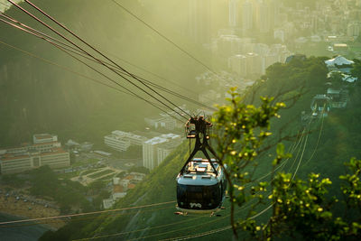 High angle view of overhead cable car over cityscape