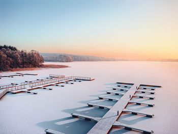 Aerial view of lake against clear sky during winter