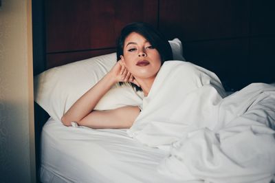 Woman sitting on bed