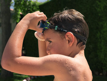 Portrait of shirtless boy in water