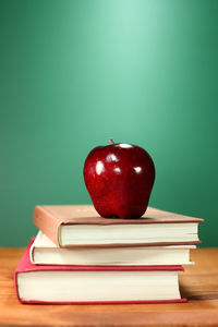 Stack of red apple on table