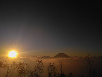 Scenic view of silhouette mountains against sky during sunset